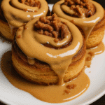 Served Biscoff cinnamon rolls with glaze and cookie crumbles